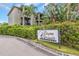 Bayou Grande townhomes community sign on a sunny day, surrounded by greenery at 7130 102Nd Ln, Seminole, FL 33772