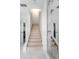 Bright staircase featuring wooden steps, modern design, and leading to the upper level of the home at 7130 102Nd Ln, Seminole, FL 33772