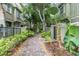 Beautiful walkway leading to townhomes with lush tropical landscaping, and privacy fencing at 7130 102Nd Ln, Seminole, FL 33772