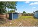 A spacious backyard with well-kept lawn and a shed, enclosed by a wooden fence for privacy at 731 20Th Nw St, Largo, FL 33770
