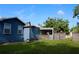 Exterior view of a well-maintained home with a fenced-in yard, screen porch, and lush green lawn at 731 20Th Nw St, Largo, FL 33770