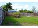 Fenced backyard with plenty of lawn space and an old growth stump of plant matter at 731 20Th Nw St, Largo, FL 33770