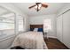Bedroom with bed, ceiling fan, closet, and natural light from two windows at 731 20Th Nw St, Largo, FL 33770