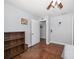 Bedroom featuring hardwood floors, a ceiling fan, and an open doorway at 731 20Th Nw St, Largo, FL 33770
