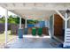 Covered parking area with plenty of space for vehicles, features privacy fencing, and a wooden accent wall at 731 20Th Nw St, Largo, FL 33770