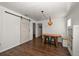 Charming dining space with wood table, decorative lighting, and a sliding barn door at 731 20Th Nw St, Largo, FL 33770