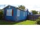View of the side of the home with lawn, showing windows, trim and exterior home details at 731 20Th Nw St, Largo, FL 33770