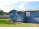 Exterior view of the home's back, featuring windows, grass, and access to the backyard at 731 20Th Nw St, Largo, FL 33770