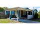 Blue house with covered carport featuring privacy fence, parking, and exterior home details at 731 20Th Nw St, Largo, FL 33770