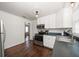 Bright kitchen features stainless steel appliances, white cabinets, and a view to another room at 731 20Th Nw St, Largo, FL 33770