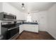 Modern kitchen with white cabinets, stainless steel appliances, and sleek countertops at 731 20Th Nw St, Largo, FL 33770