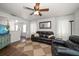 Bright living room featuring leather sofas, ceiling fan, and a decorative rug at 731 20Th Nw St, Largo, FL 33770