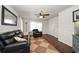 Cozy living room with leather seating, a ceiling fan, and hardwood floors at 731 20Th Nw St, Largo, FL 33770