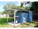 Backyard shed with a grill, perfect for outdoor cooking, adding functionality to the green backyard space at 731 20Th Nw St, Largo, FL 33770
