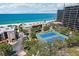 Spectacular aerial view of condos near the beach with two well-maintained tennis courts at 7564 Bayshore Dr # 302, Treasure Island, FL 33706