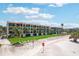 Aerial shot of condo buildings with manicured lawns, and direct beach access at 7564 Bayshore Dr # 302, Treasure Island, FL 33706