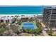 Stunning aerial view of condos complex, tennis courts and beach at 7564 Bayshore Dr # 302, Treasure Island, FL 33706