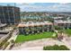 An aerial view of a condo complex with mature trees, on the white sand beach at 7564 Bayshore Dr # 302, Treasure Island, FL 33706