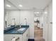 Bathroom vanity with a bright blue countertop, complemented by white cabinetry and modern fixtures at 7564 Bayshore Dr # 302, Treasure Island, FL 33706