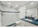 Modern bathroom featuring a glass-enclosed shower with blue tiling and a vanity with a striking blue countertop at 7564 Bayshore Dr # 302, Treasure Island, FL 33706