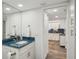 Bathroom vanity with a bright blue countertop, complemented by white cabinetry and modern fixtures at 7564 Bayshore Dr # 302, Treasure Island, FL 33706