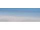 Calm, clear ocean water gently washing onto a pristine white sand beach at 7564 Bayshore Dr # 302, Treasure Island, FL 33706