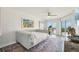 Bright bedroom with a comfortable daybed, colorful art, and a balcony offering scenic views at 7564 Bayshore Dr # 302, Treasure Island, FL 33706