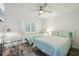 Bright bedroom featuring twin beds, modern furniture, and a well-lit workspace at 7564 Bayshore Dr # 302, Treasure Island, FL 33706