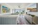 Stylish bedroom highlighting a daybed, balcony views, and chic furnishings at 7564 Bayshore Dr # 302, Treasure Island, FL 33706
