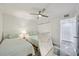Comfortable bedroom with twin beds, a ceiling fan, and ample closet space at 7564 Bayshore Dr # 302, Treasure Island, FL 33706