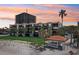 Stunning beachfront condo building with manicured lawn and charming gazebo, with blue sky at 7564 Bayshore Dr # 302, Treasure Island, FL 33706