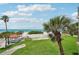 Lovely beach view with clear skies and green grass from outdoor community gazebo at 7564 Bayshore Dr # 302, Treasure Island, FL 33706