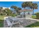 Picturesque gazebo with a picnic table, set among tropical palm trees, near the water at 7564 Bayshore Dr # 302, Treasure Island, FL 33706