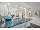 Spacious kitchen with beautiful blue countertops and white cabinets, complemented by modern stainless-steel appliances at 7564 Bayshore Dr # 302, Treasure Island, FL 33706