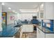 Modern laundry room with stacked washer and dryer next to updated kitchen at 7564 Bayshore Dr # 302, Treasure Island, FL 33706