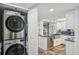 Side view of the kitchen showing open laundry closet with front loading washer and dryer at 7564 Bayshore Dr # 302, Treasure Island, FL 33706