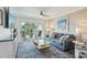 Comfortable living room with a sliding glass door leading to a balcony with ocean views at 7564 Bayshore Dr # 302, Treasure Island, FL 33706