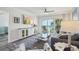 Bright living room with stylish decor, comfortable seating, and balcony access offering stunning ocean views at 7564 Bayshore Dr # 302, Treasure Island, FL 33706