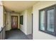Porch with a secure entry door and a window, offering a blend of privacy and natural light at 7564 Bayshore Dr # 302, Treasure Island, FL 33706
