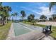 Outdoor shuffleboard courts and palm trees offer an active and tropical lifestyle at 7564 Bayshore Dr # 302, Treasure Island, FL 33706