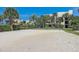 Sandy outdoor volleyball court surrounded by lush greenery and palm trees at 7564 Bayshore Dr # 302, Treasure Island, FL 33706