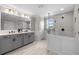 Modern bathroom features double vanity, spacious glass shower, and updated fixtures at 7819 Notched Pine Bnd, Wesley Chapel, FL 33545