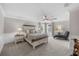 A serene bedroom with a king-sized bed, stylish lamps, and cozy chaise lounge at 7819 Notched Pine Bnd, Wesley Chapel, FL 33545