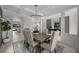 Formal dining room with wood floors, elegant chandelier, and seating for six at 7819 Notched Pine Bnd, Wesley Chapel, FL 33545