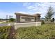 Elegant stone community sign at Whispering Oaks Preserve with lush landscaping at 7819 Notched Pine Bnd, Wesley Chapel, FL 33545