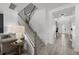 Bright foyer featuring a staircase, modern lighting, and wood-look flooring at 7819 Notched Pine Bnd, Wesley Chapel, FL 33545