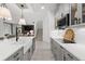 Gourmet kitchen with stainless steel appliances and a view into the living room and stairway at 7819 Notched Pine Bnd, Wesley Chapel, FL 33545