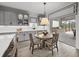 A combined kitchen and breakfast nook area leading to a fully equipped outdoor kitchen at 7819 Notched Pine Bnd, Wesley Chapel, FL 33545