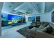 Ambient living room with a large screen and comfortable seating offers a modern and inviting space at 7819 Notched Pine Bnd, Wesley Chapel, FL 33545