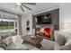 Stylish living room with a fireplace and sliding doors leading to the pool area at 7819 Notched Pine Bnd, Wesley Chapel, FL 33545
